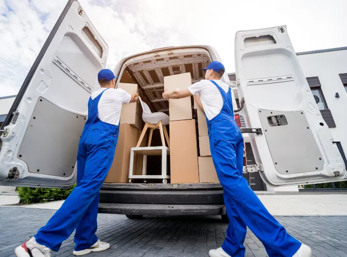 Movers loading a truck with boxes