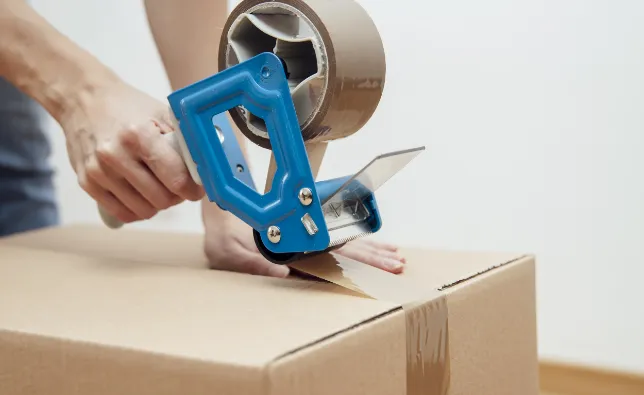 Mover taping a box