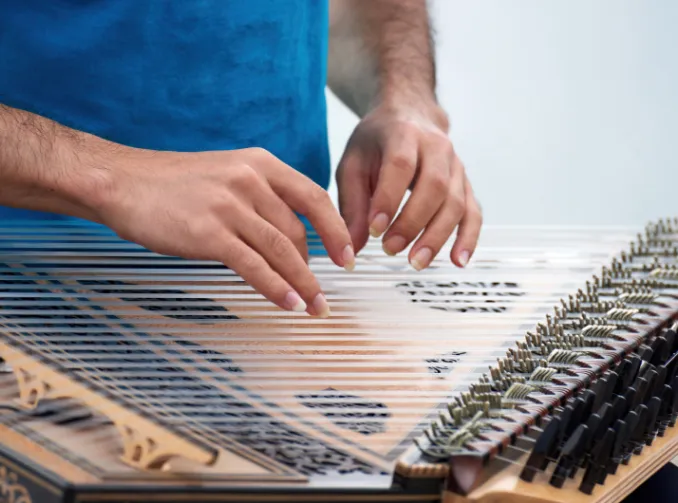 Person adjusting piano strings