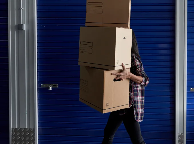 Person carrying stacked boxes